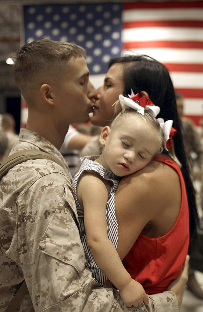Andrew Thai kisses his wife, Sarah, as his daughter, Mikalah, sleeps, upon his return to Hawaii on June 14, 2010, following a seven-month deployment in southern Afghanistan.
Andrew Thai kisses his wife, Sarah, as his daughter, Mikalah, sleeps, upon his return to Hawaii on June 14, 2010, following a seven-month deployment in southern Afghanistan.