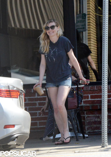 Kirsten Dunst smiled as she carried her iced coffee to the car. Kirsten Dunst smiled as she carried her iced coffee to the car.