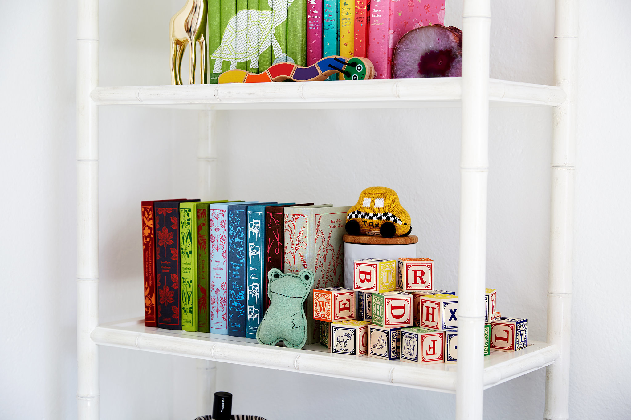 Colorful design classics share shelf space with a set of stacked