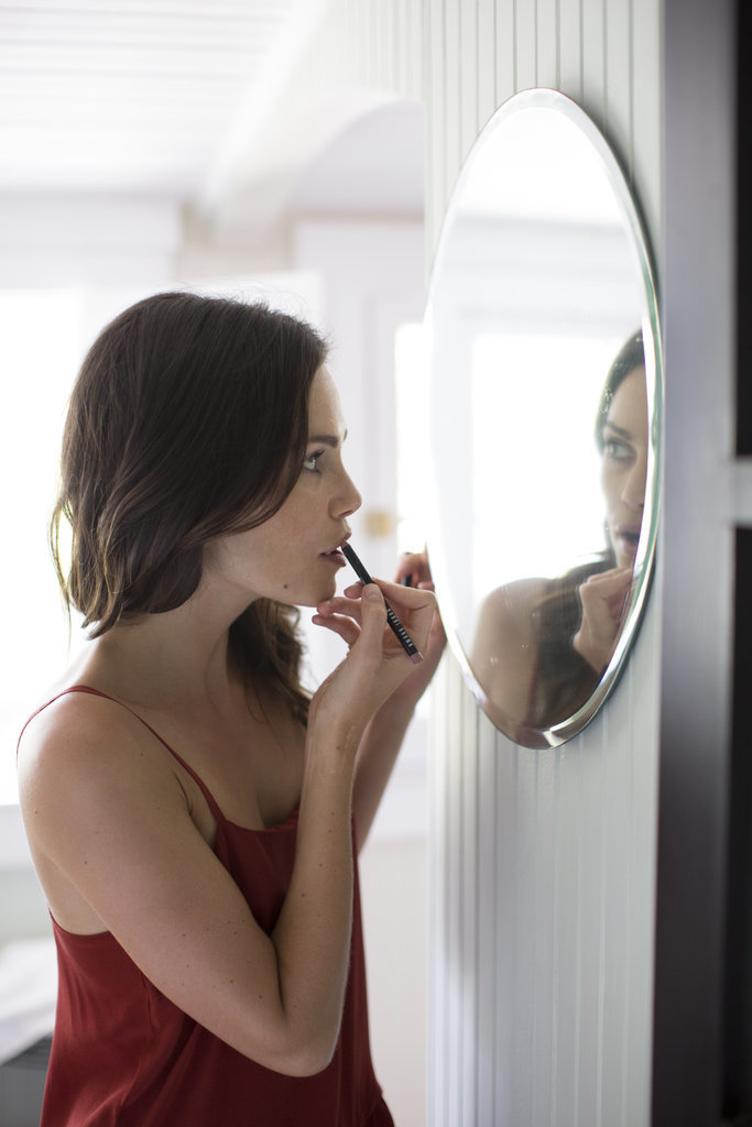 Applying lip liner just to the edges.