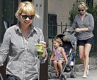 Michelle Williams in a black and white gingham shirt with baby Matilda Michelle Williams in a black and white gingham shirt with baby Matilda